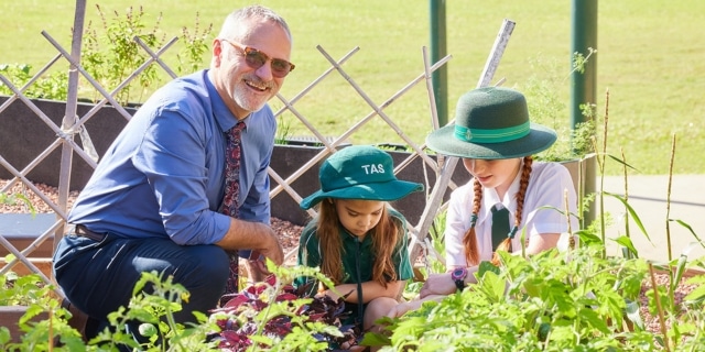 TAS' Head of Junior School (White Rock Campus) Mr Peter Gazzola with primary students. PHOTO: Romy Photography